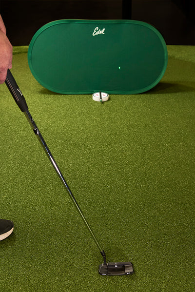Edel Golf Aim Check w/ laser pointed on backdrop